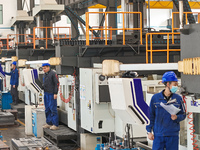 Workers produce slitting machine parts at Qingdao Kaisheng CNC Equipment Co., LTD., in Qingdao, China, on November 28, 2024. (