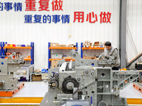 Workers assemble shuttleless looms at Qingdao Century Haijia Machinery Co., LTD in Qingdao, China, on November 28, 2024. (