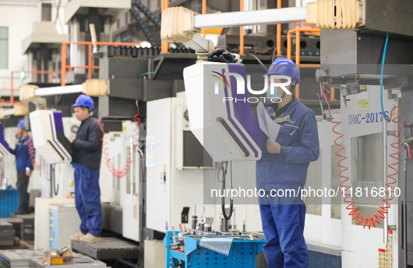 Workers produce slitting machine parts at Qingdao Kaisheng CNC Equipment Co., LTD., in Qingdao, China, on November 28, 2024. 