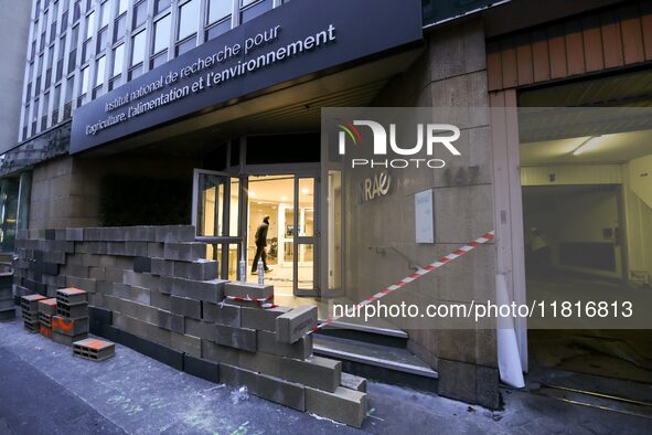 French farmers construct a symbolic wall in front of the French National Institute for Agricultural Research (INRAE) head office to represen...