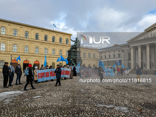 Activists gather at the Residenz in Munich, Germany, on December 10, 2023, to protest the genocide of Uyghurs. Participants hold a prominent...