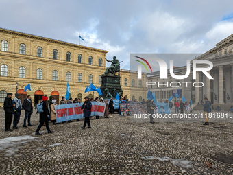 Activists gather at the Residenz in Munich, Germany, on December 10, 2023, to protest the genocide of Uyghurs. Participants hold a prominent...