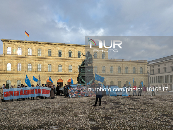 Activists gather at the Residenz in Munich, Germany, on December 10, 2023, to protest the genocide of Uyghurs. Participants hold a prominent...