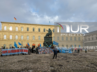 Activists gather at the Residenz in Munich, Germany, on December 10, 2023, to protest the genocide of Uyghurs. Participants hold a prominent...