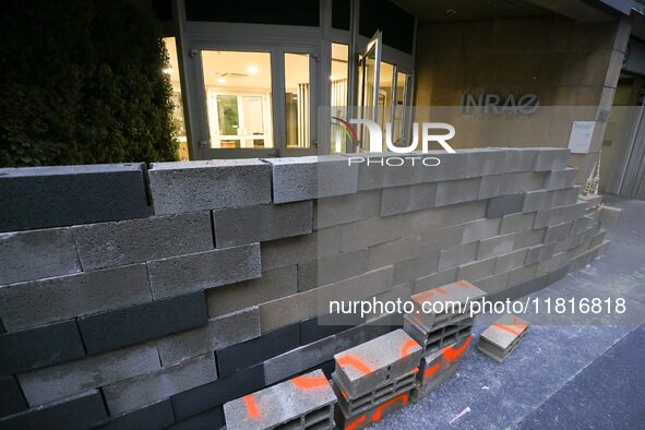 French farmers construct a symbolic wall in front of the French National Institute for Agricultural Research (INRAE) head office to represen...