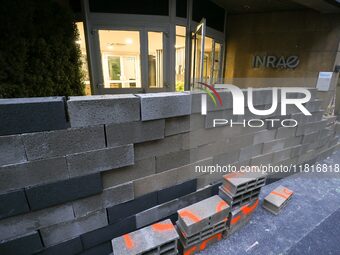 French farmers construct a symbolic wall in front of the French National Institute for Agricultural Research (INRAE) head office to represen...