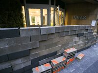 French farmers construct a symbolic wall in front of the French National Institute for Agricultural Research (INRAE) head office to represen...