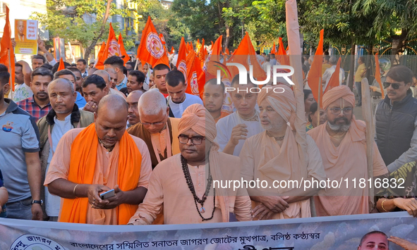 Activists of India's Hindu Jagaran Mancha, along with monks of ISKCON, hold placards showing a photo of Chinmoy Krishna Das Brahmachari, a B...