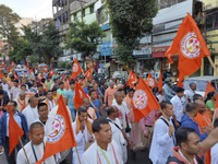 Activists of India's Hindu Jagaran Mancha, along with monks of ISKCON, hold placards showing a photo of Chinmoy Krishna Das Brahmachari, a B...