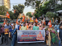 Activists of India's Hindu Jagaran Mancha, along with monks of ISKCON, hold placards showing a photo of Chinmoy Krishna Das Brahmachari, a B...