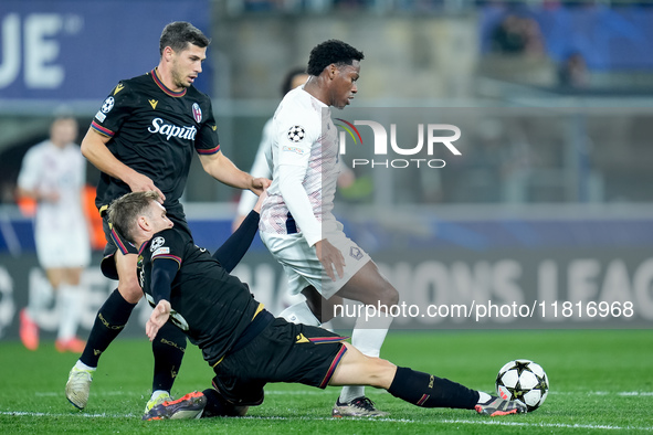 Stefan Posch of Bologna FC and Jonathan David of LOSC Lille compete for the ball during the UEFA Champions League 2024/25 League Phase MD5 m...