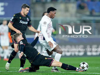 Stefan Posch of Bologna FC and Jonathan David of LOSC Lille compete for the ball during the UEFA Champions League 2024/25 League Phase MD5 m...