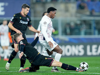 Stefan Posch of Bologna FC and Jonathan David of LOSC Lille compete for the ball during the UEFA Champions League 2024/25 League Phase MD5 m...