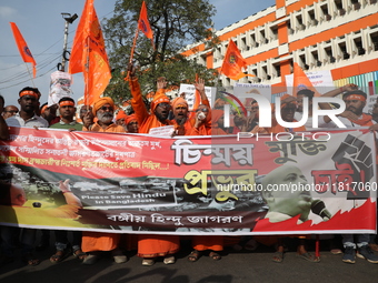 Members of Hindu Jagaran Monch shout slogans during a protest march towards the Bangladesh consulate against the recent arrest of ISKCON Ban...