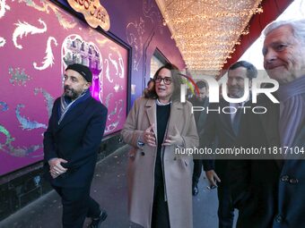 French Delegate Minister of Tourism Economy Marina Ferrari (2L), accompanied by Galeries Lafayette department store chairman Philippe Houze...