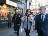 French Delegate Minister of Tourism Economy Marina Ferrari (C) observes the Christmas windows outside the Printemps department store in cent...