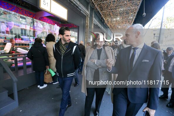 French Delegate Minister of Tourism Economy Marina Ferrari (C) observes the Christmas windows outside the Printemps department store in cent...