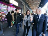 French Delegate Minister of Tourism Economy Marina Ferrari (C) observes the Christmas windows outside the Printemps department store in cent...