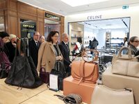 French Delegate Minister of Tourism Economy Marina Ferrari (C) observes the Christmas windows outside the Printemps department store in cent...