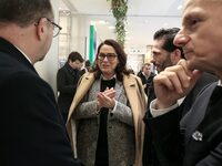 French Delegate Minister of Tourism Economy Marina Ferrari (C) observes the Christmas windows outside the Printemps department store in cent...