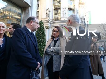 French Delegate Minister of Tourism Economy Marina Ferrari (C) observes the Christmas windows outside the Printemps department store in cent...