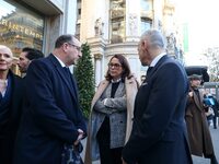 French Delegate Minister of Tourism Economy Marina Ferrari (C) observes the Christmas windows outside the Printemps department store in cent...