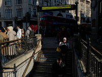 People descend into the Oxford Circus underground station in London, United Kingdom, on November 28, 2024. (