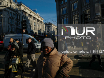 People walk in Oxford Circus, London, on November 28, 2024. (