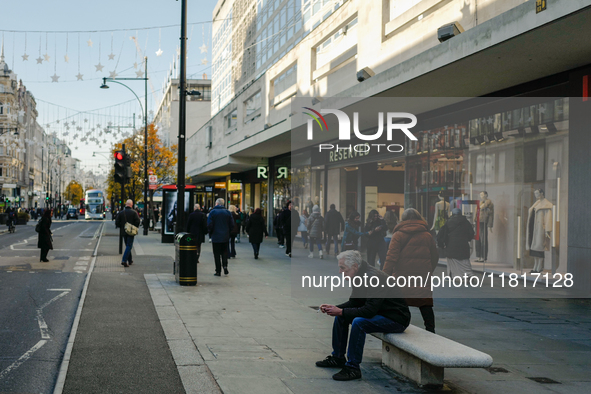 People walk on Oxford Street in London, United Kingdom, on November 28, 2024. 