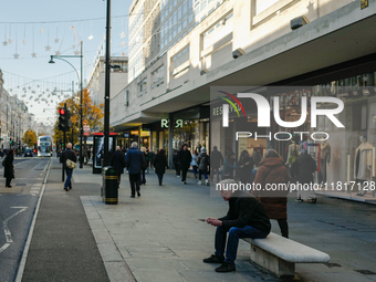 People walk on Oxford Street in London, United Kingdom, on November 28, 2024. (