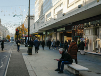 People walk on Oxford Street in London, United Kingdom, on November 28, 2024. (