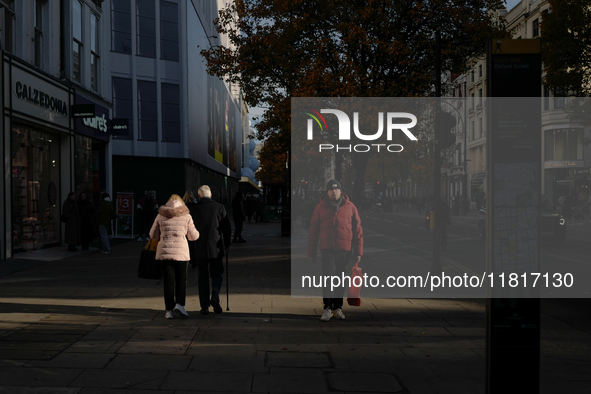 People walk on Oxford Street in London, United Kingdom, on November 28, 2024. 