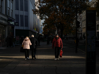 People walk on Oxford Street in London, United Kingdom, on November 28, 2024. (