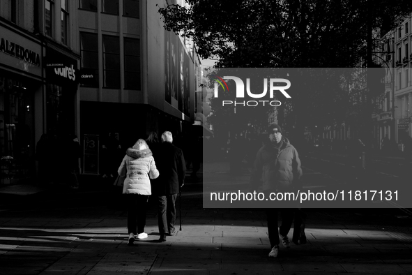 People walk on Oxford Street in London, United Kingdom, on November 28, 2024. 