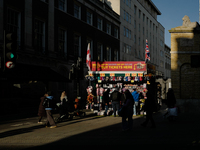 People walk past a souvenirs kiosk on Oxford Street in London, England, on November 28, 2024. (