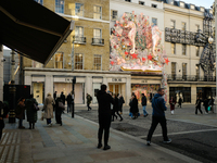 Christmas decorations are placed on the facades of shop windows in Mayfair, London, on November 28, 2024, the day before Black Friday. (