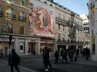 Christmas decorations are placed on the facades of shop windows in Mayfair, London, on November 28, 2024, the day before Black Friday. (