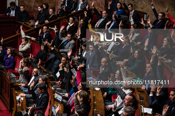 Members of the New Popular Front vote during the debate on amendments in Parliament on the repeal of the pension reform in Paris, France, on...