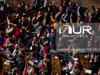 Members of the New Popular Front vote during the debate on amendments in Parliament on the repeal of the pension reform in Paris, France, on...