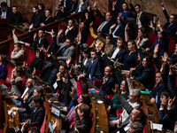 Members of the New Popular Front vote during the debate on amendments in Parliament on the repeal of the pension reform in Paris, France, on...