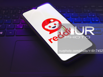 The Reddit logo appears on the screen of a smartphone that rests on top of a laptop keyboard in Reno, United States, on November 28, 2024. (