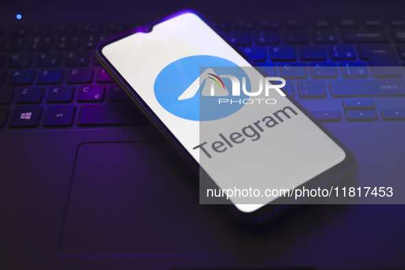 The Telegram logo appears on the screen of a smartphone that rests on top of a laptop keyboard in Reno, United States, on November 28, 2024....