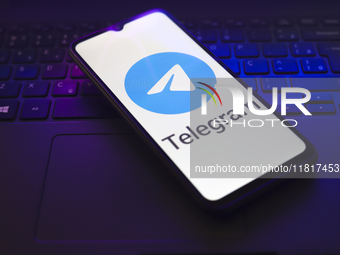 The Telegram logo appears on the screen of a smartphone that rests on top of a laptop keyboard in Reno, United States, on November 28, 2024....