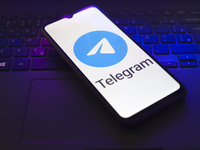 The Telegram logo appears on the screen of a smartphone that rests on top of a laptop keyboard in Reno, United States, on November 28, 2024....