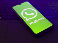 The WhatsApp logo appears on the screen of a smartphone that is on top of the laptop keyboard in Reno, United States, on November 28, 2024....