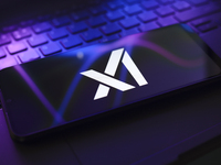 The X.AI Corp. logo appears on the screen of a smartphone that rests on top of the laptop keyboard in Reno, United States, on November 28, 2...