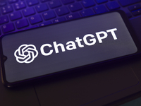 The ChatGPT logo appears on the screen of a smartphone that rests on top of the laptop keyboard in Reno, United States, on November 28, 2024...