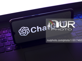 The ChatGPT logo appears on the screen of a smartphone that rests on top of the laptop keyboard in Reno, United States, on November 28, 2024...