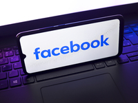 The Facebook logo appears on the screen of a smartphone that rests on top of a laptop keyboard in Reno, United States, on November 28, 2024....