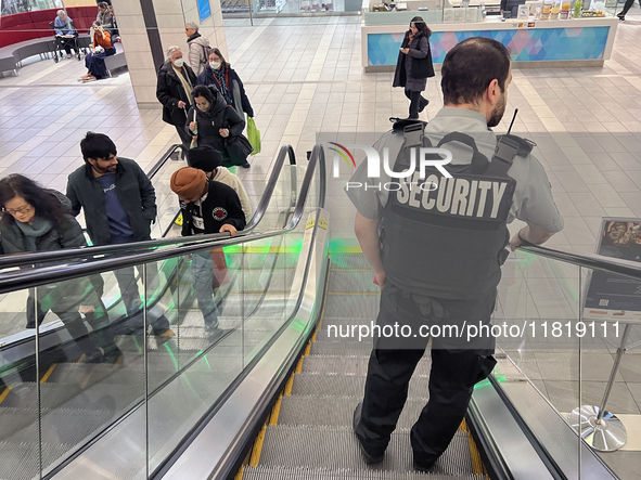 A security guard patrols a shopping mall in Toronto, Ontario, Canada, on November 28, 2024. 